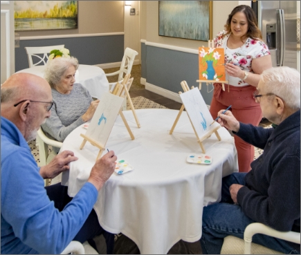 Photo of some seniors painting pictures.